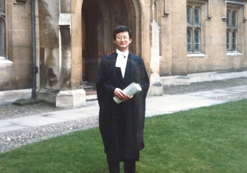 Prof. Wang in front of Sidney Sussex College at PHD graduation, Cambridge, 1987