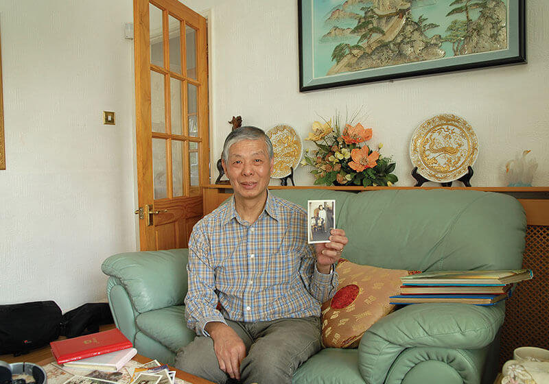 Mr. Yuk Lun Liu with his treasured old family photos