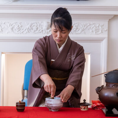 Yukie is whisking matcha tea at the Tea Ceremony.
