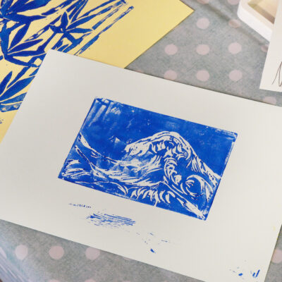 Blue ink print of a wave and bamboo